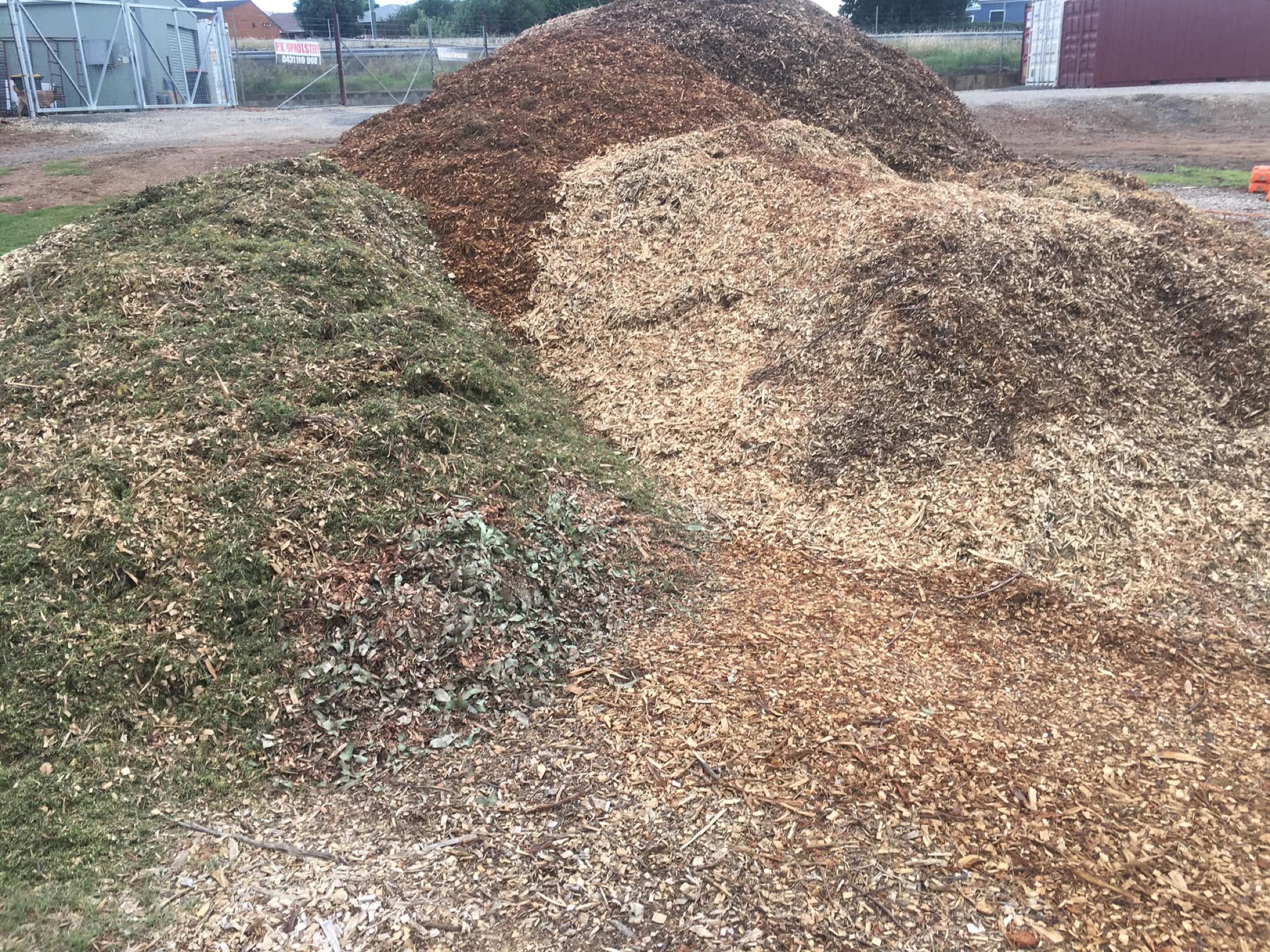 Mixed piles of garden mulch in different colours and grades