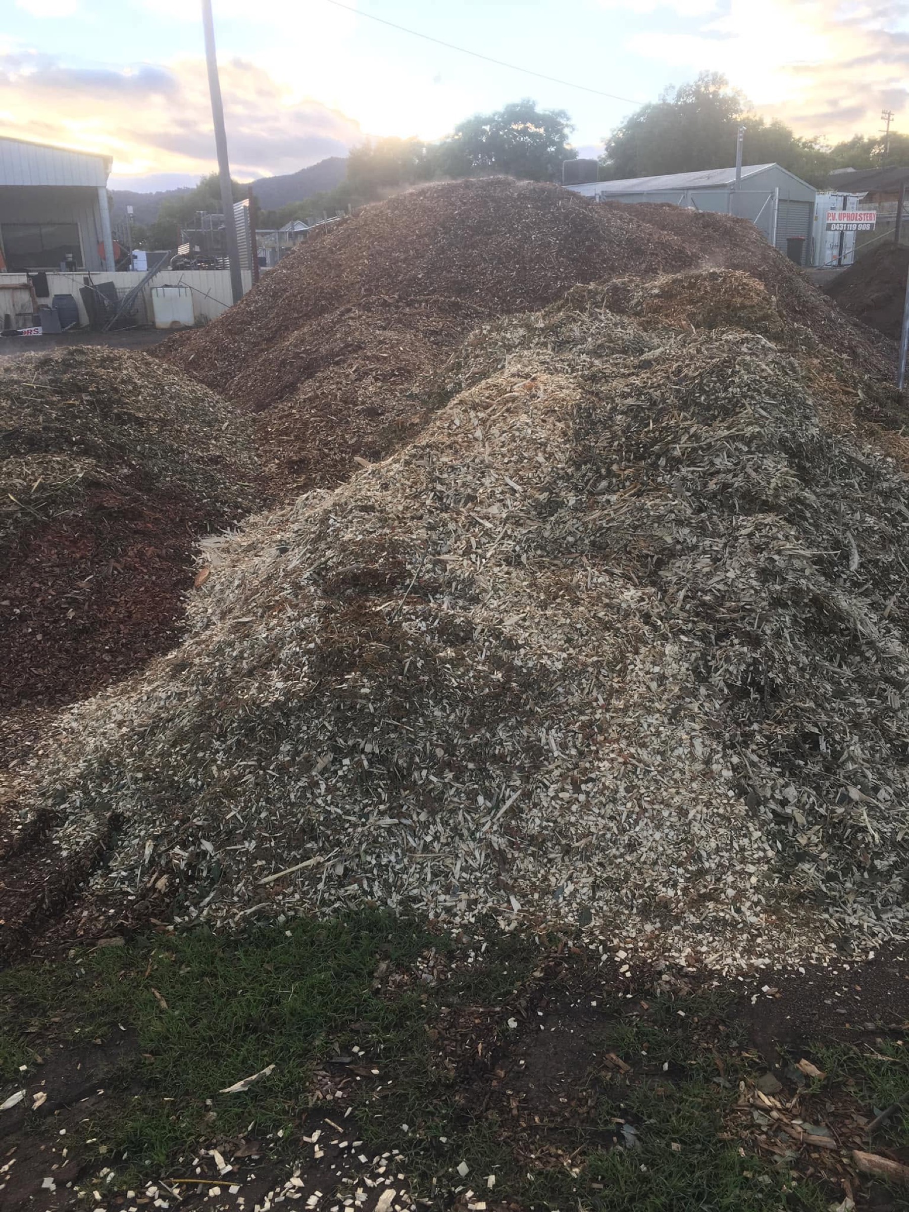 A large mound of garden mulch at golden hour, Macca's Mulch Firewood & Gravel