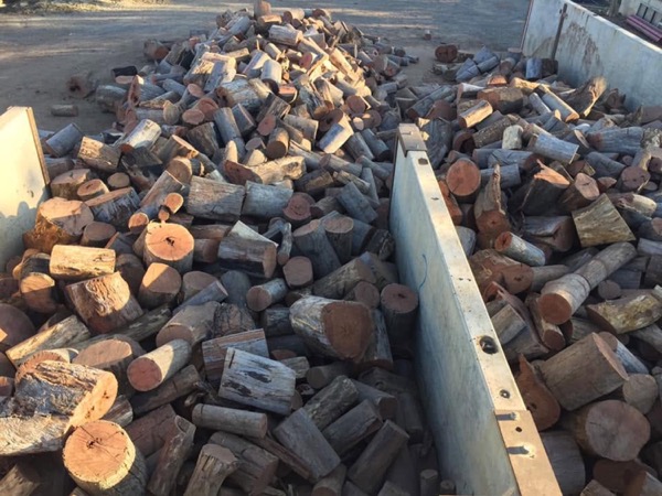 A trailer loaded with split firewood